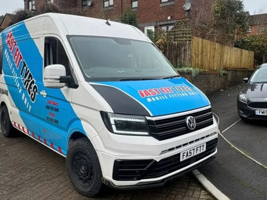 Fast Fit Tyres mobile fitting van parked on a block-paved residential street