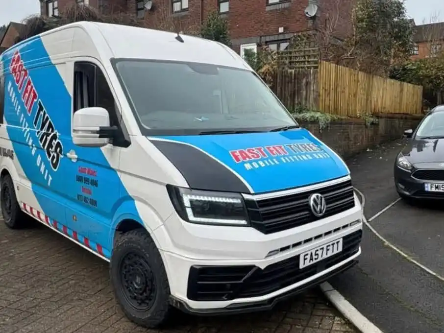Fast Fit Tyres mobile fitting van parked on a block-paved residential street